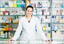 happy and cheerful pharmacist woman standing in pharmacy drugstore