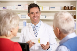 pharmacist assisting senior couple